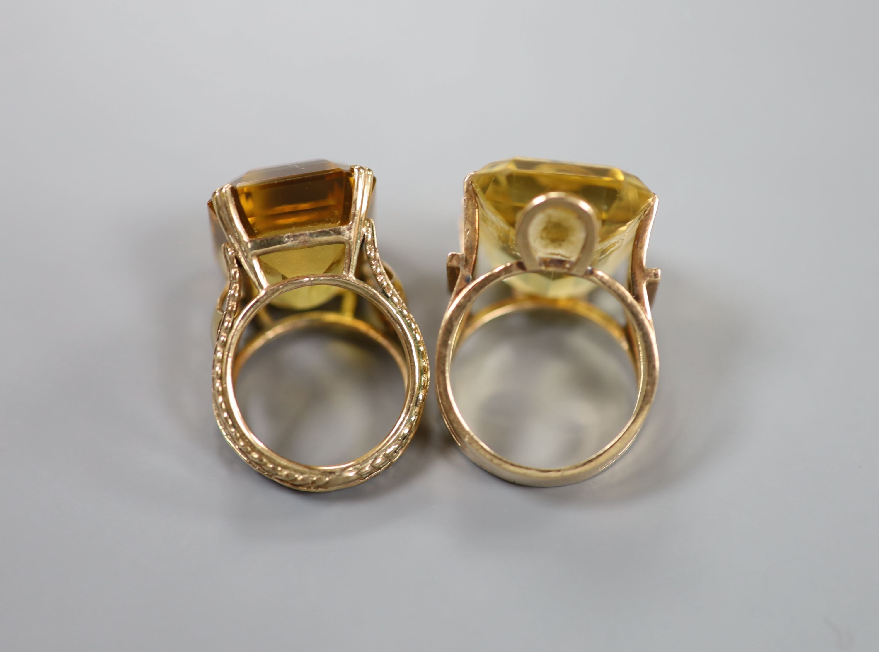 Two yellow metal and citrine set dress rings, one faintly marked 9ct, sizes L/M & P, gross weight 27 grams.